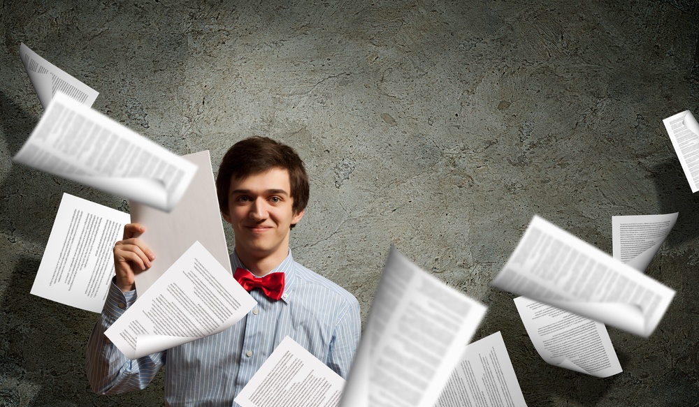 Image of young tired man holding folder with documents